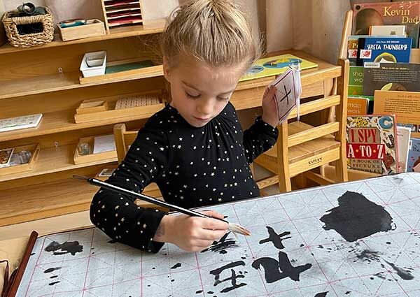 Battery-Park-Montessori-child-painting-language