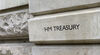 A sign on the stone wall of Her Majestys Treasury offices in Horse Guards Road, London. This government department is the ministry responsible for the economy and the nations finance: the Chancellor of the Exchequer is the most senior minister in the depa
