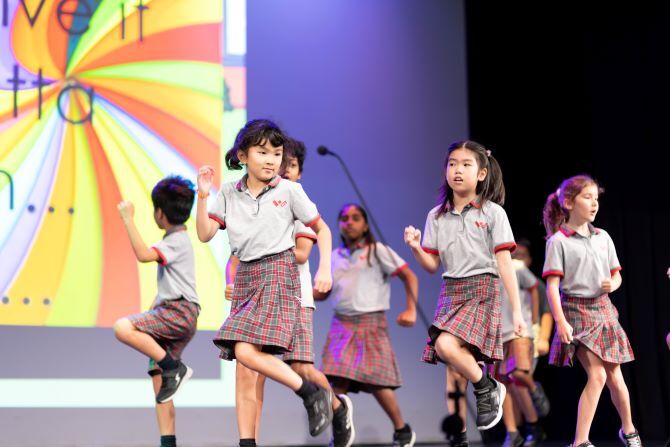 XCL World Academy children performing on stage