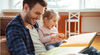 Image of father and daughter happily sharing a book