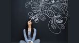 woman-cross-legged-in-front-of-blackboard-image