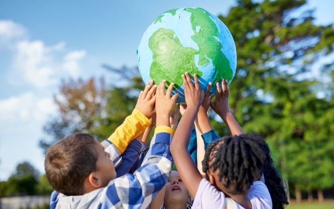 image-of-children-holding-up-globe