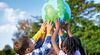 image-of-children-holding-up-globe